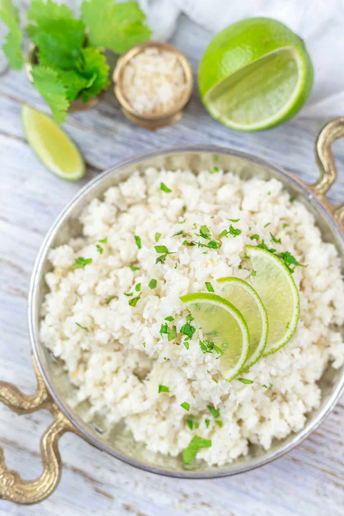 Coconut cauliflower rice recipe in a golden bowl.