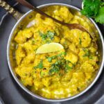 Chicken Curry served inside a gold dish.