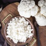 Cauliflower Rice on a wooden board.