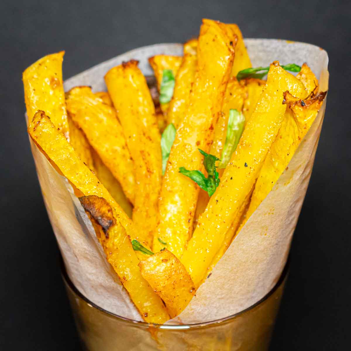 Crispy rutabaga fries served in a glass.