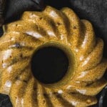 A bundt cake sitting on a black surface.