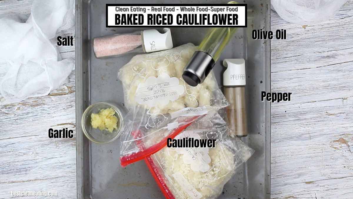 A baking sheet with ingredients for baked riced cauliflower.