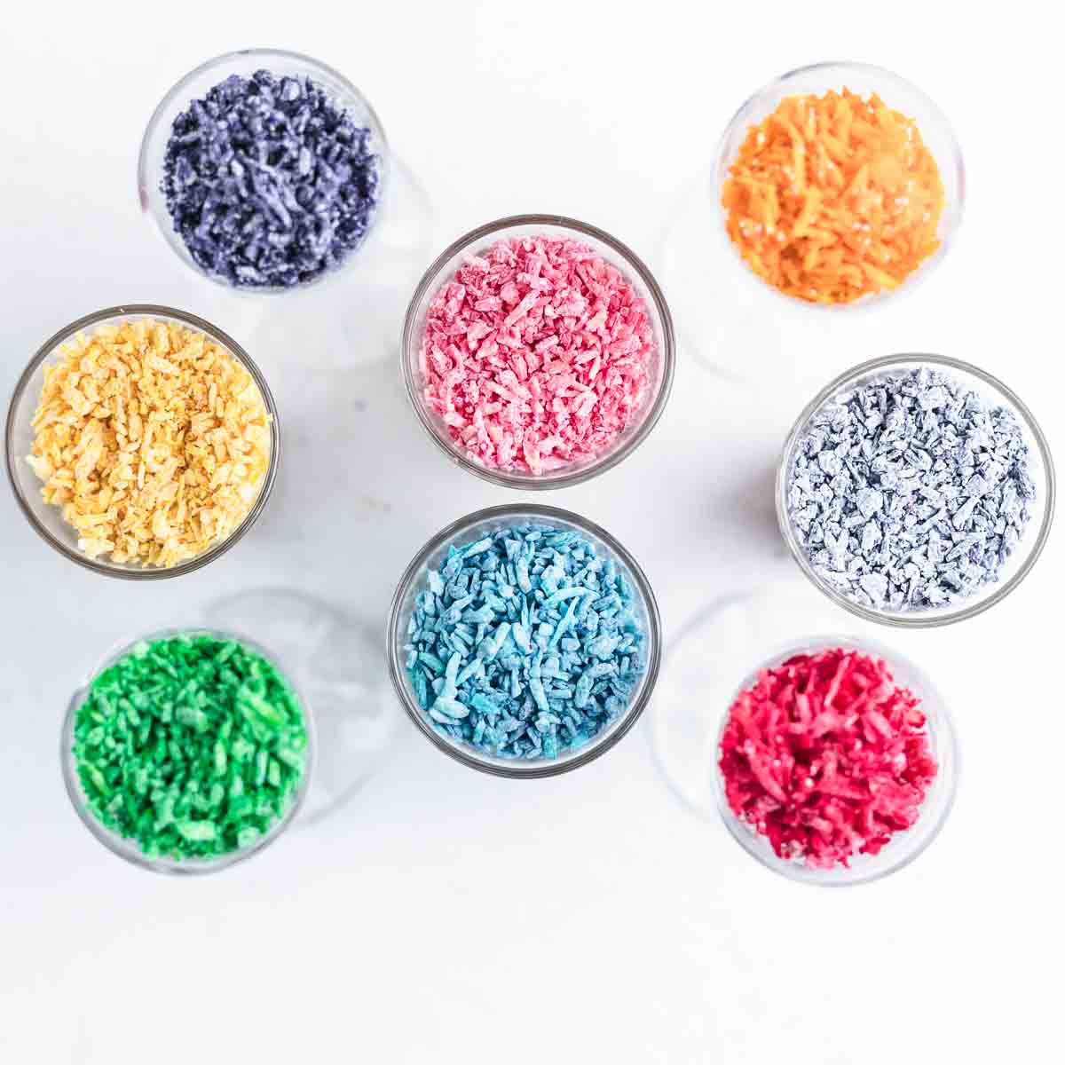 Colorful sprinkles arranged in a circle on a white surface.