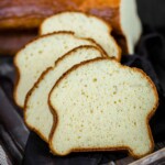 Four slices of bread on a wooden board.