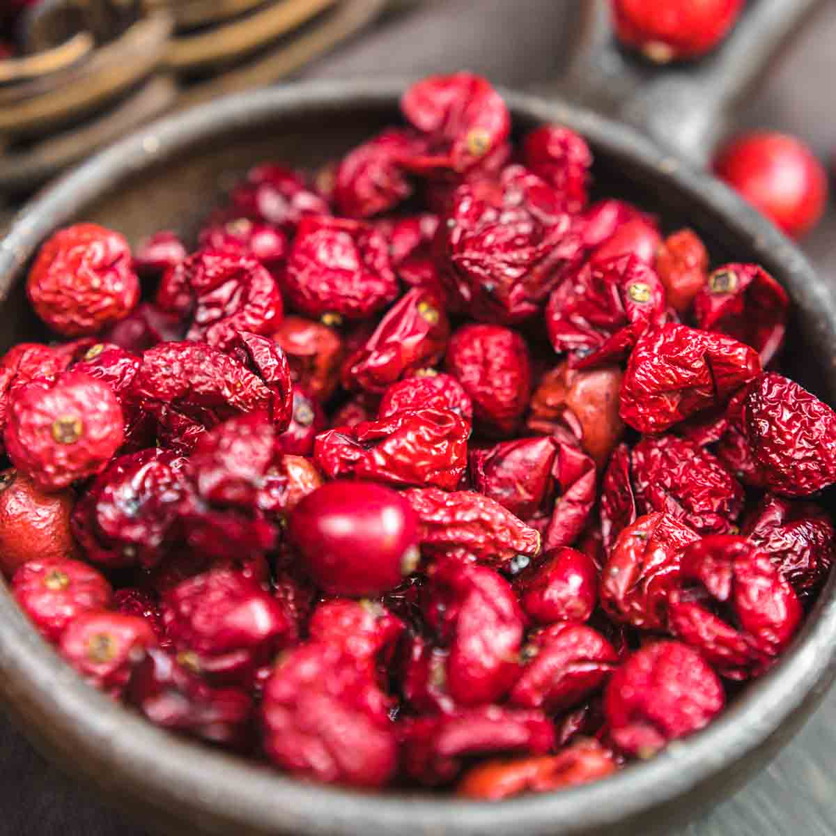 Dried cranberries in a bowl on a table.