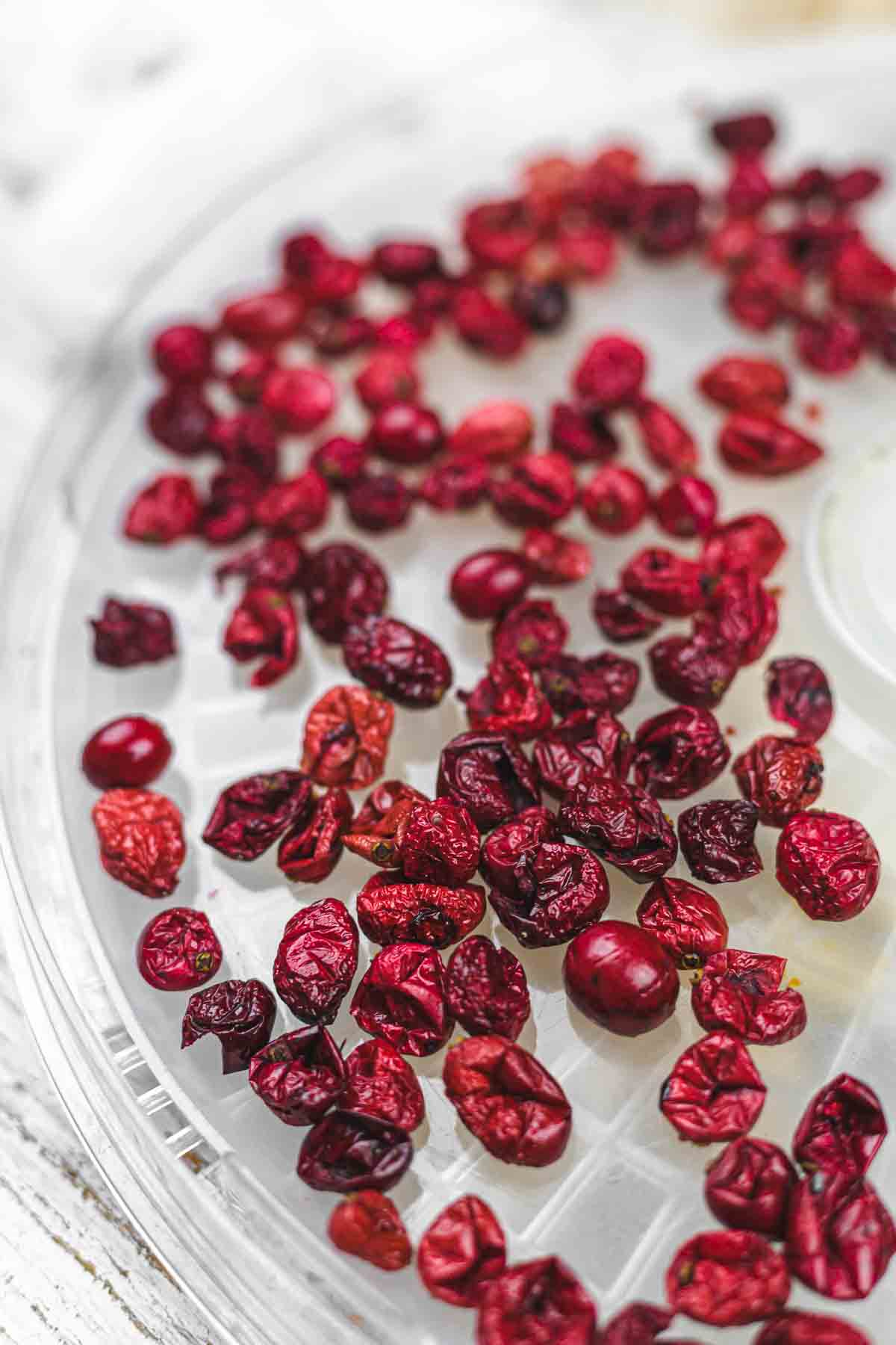 Dried cranberries on a clear plate.