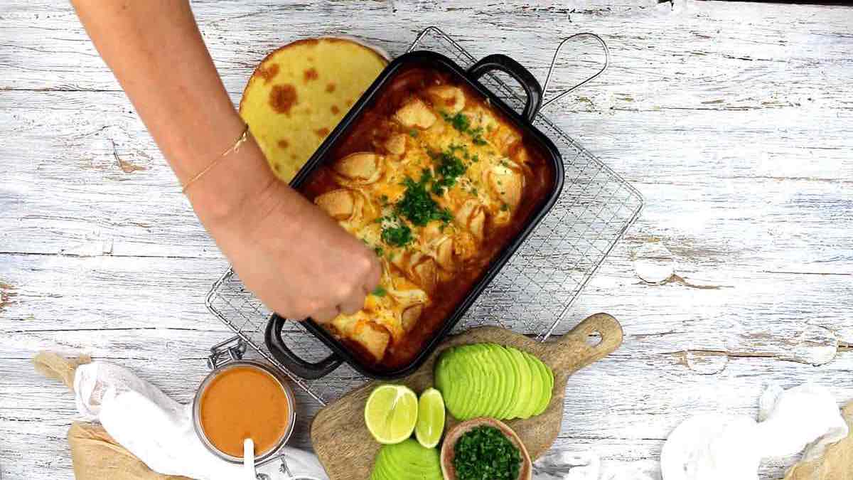 Sprinkling parsley onto enchilada.