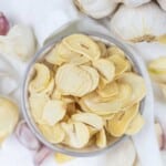 Garlic chips in a bowl on a white background.