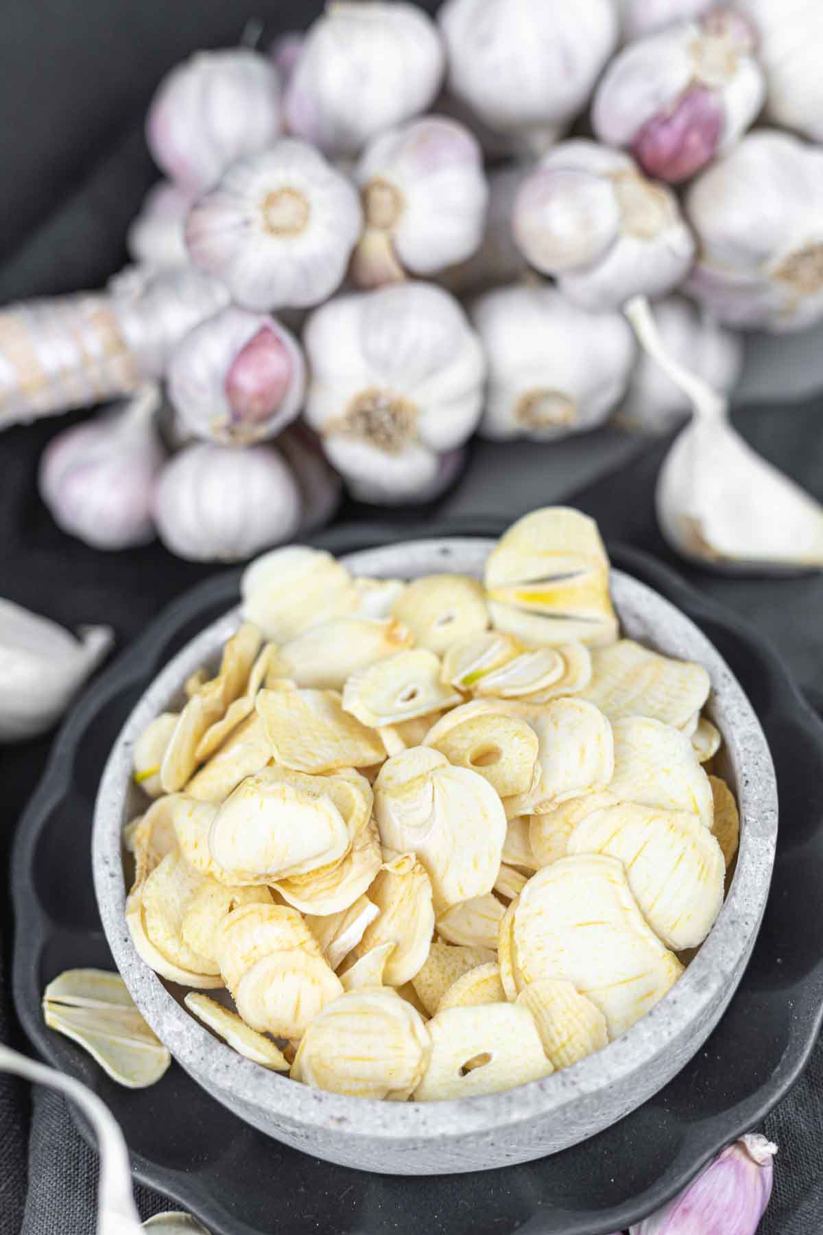 Garlic chips in a bowl on a black background.