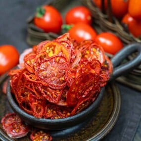 Sliced tomatoes in a bowl on a table.