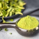 Stevia powder in a black bowl.