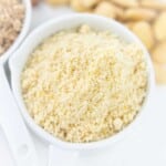 A close-up shot of a white bowl filled with almond flour.