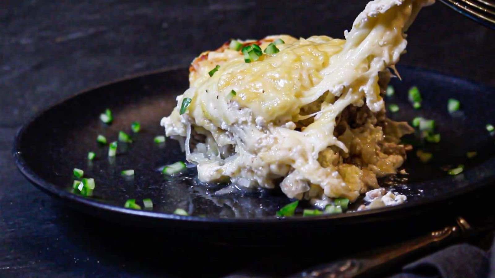 Sauerkraut casserole with ground beef on a plate, dishing with a fork.