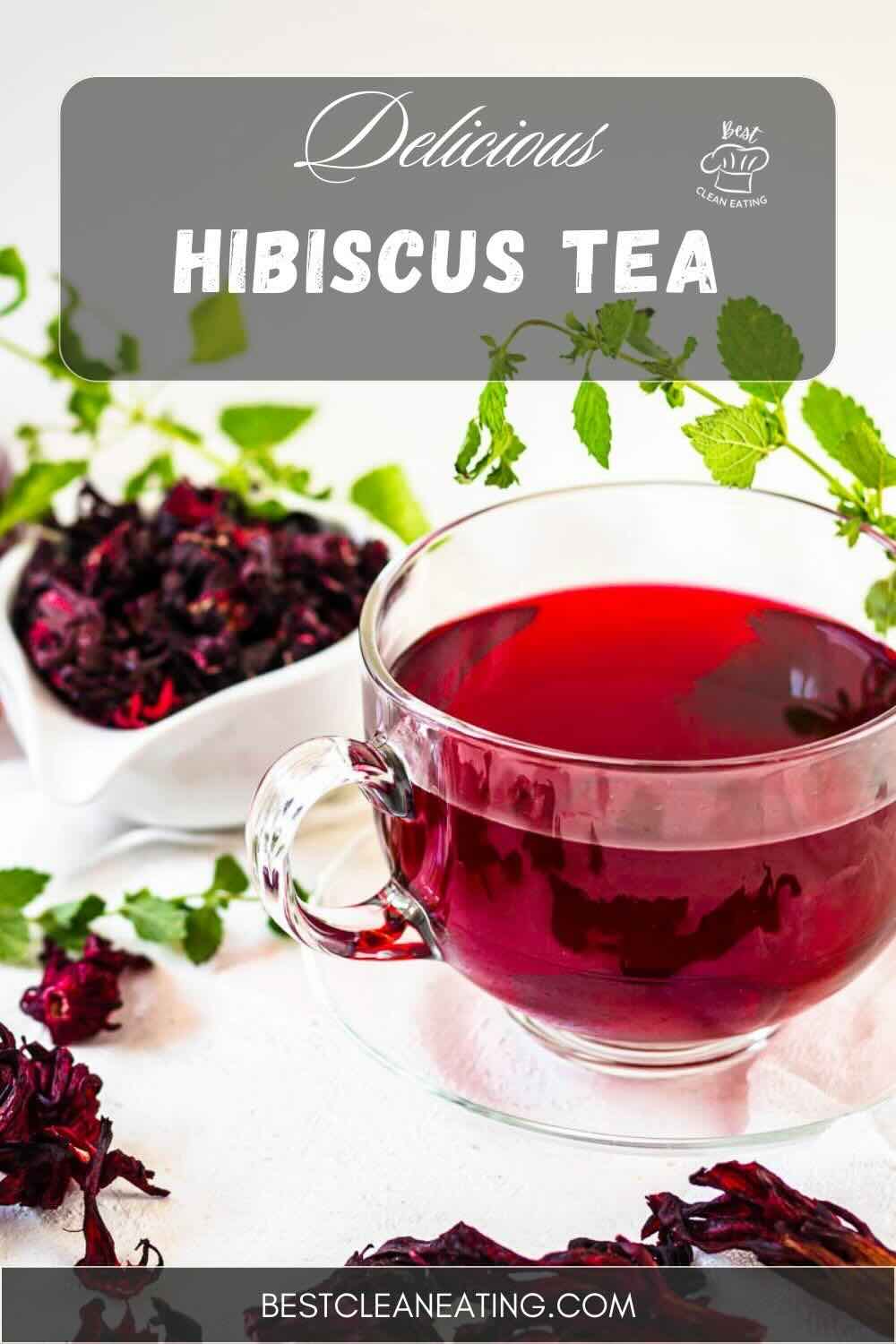 A glass cup of red hibiscus tea next to dried hibiscus petals and fresh green leaves. The text "Delicious Hibiscus Tea" is at the top, with a "Clean Eating" icon and a "tinybatchcooking.com" URL at the bottom.