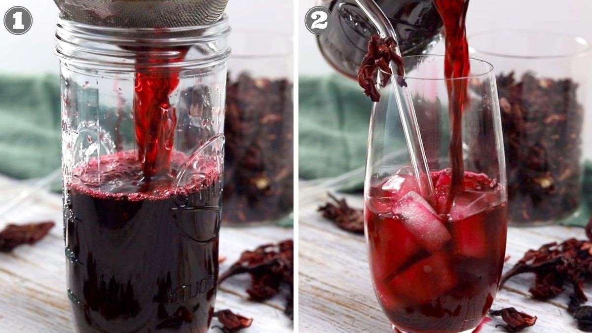 A jar is filled with dark red hibiscus tea through a strainer. The tea is then poured over ice in a clear glass. Dried hibiscus petals and another glass are in the background.