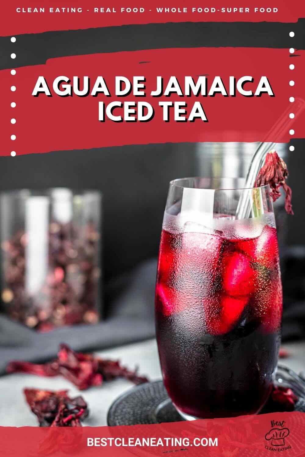 A chilled glass of Agua de Jamaica iced tea with ice cubes and hibiscus petals, set against a blurred background. The top of the image features a red banner with text describing the drink.