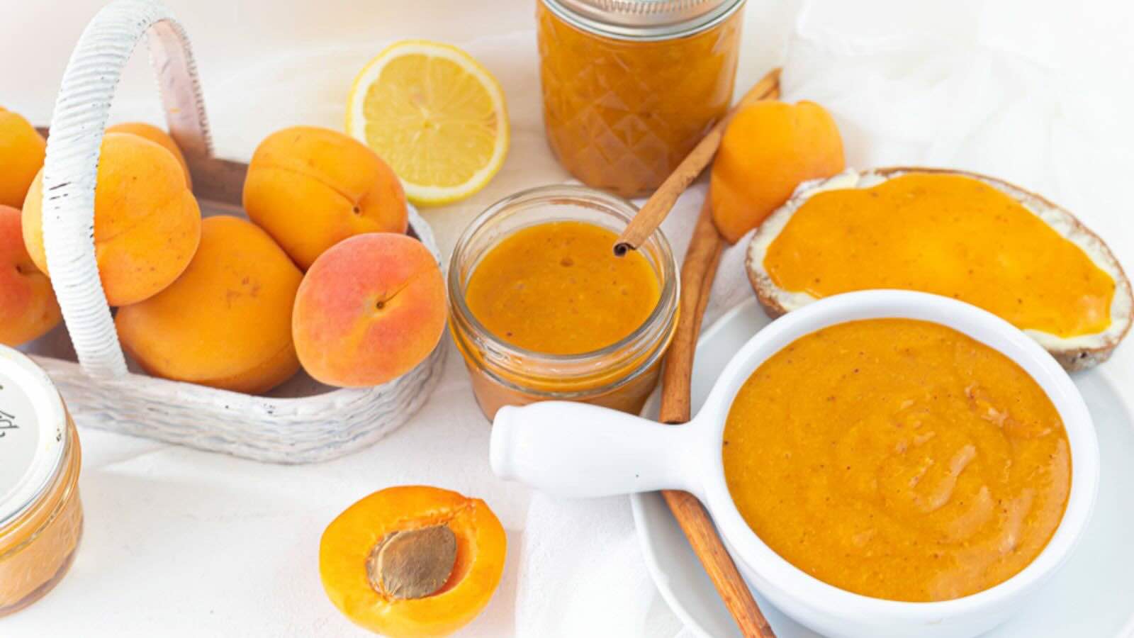 A wicker basket filled with apricots and preserves.