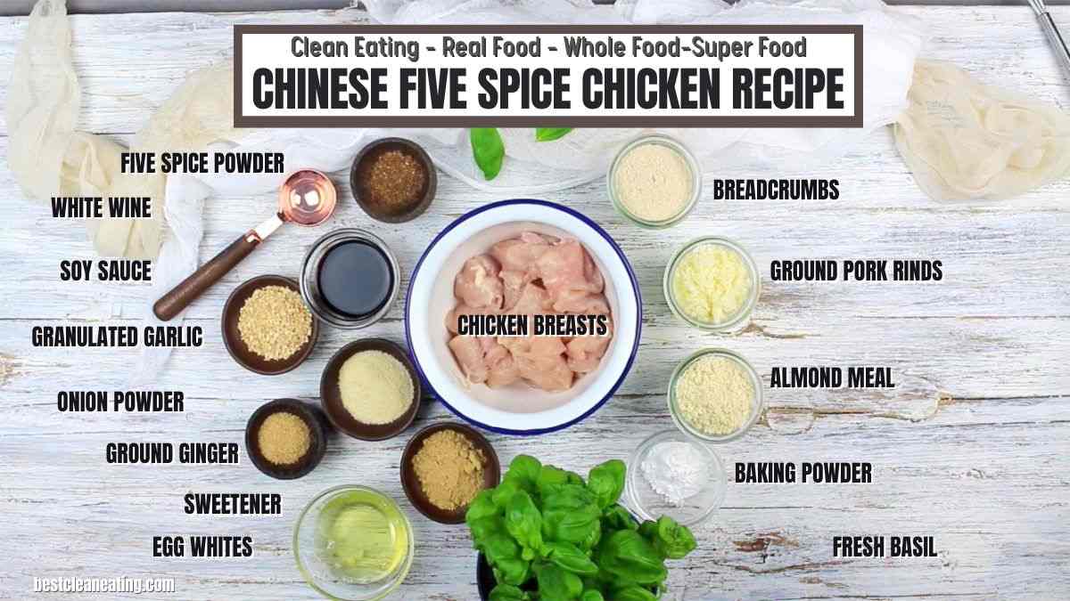 Ingredients for Chinese Five Spice Chicken Recipe neatly arranged on a table, including chicken breasts, soy sauce, white wine, five spice powder, and more. Text labels identify each item.