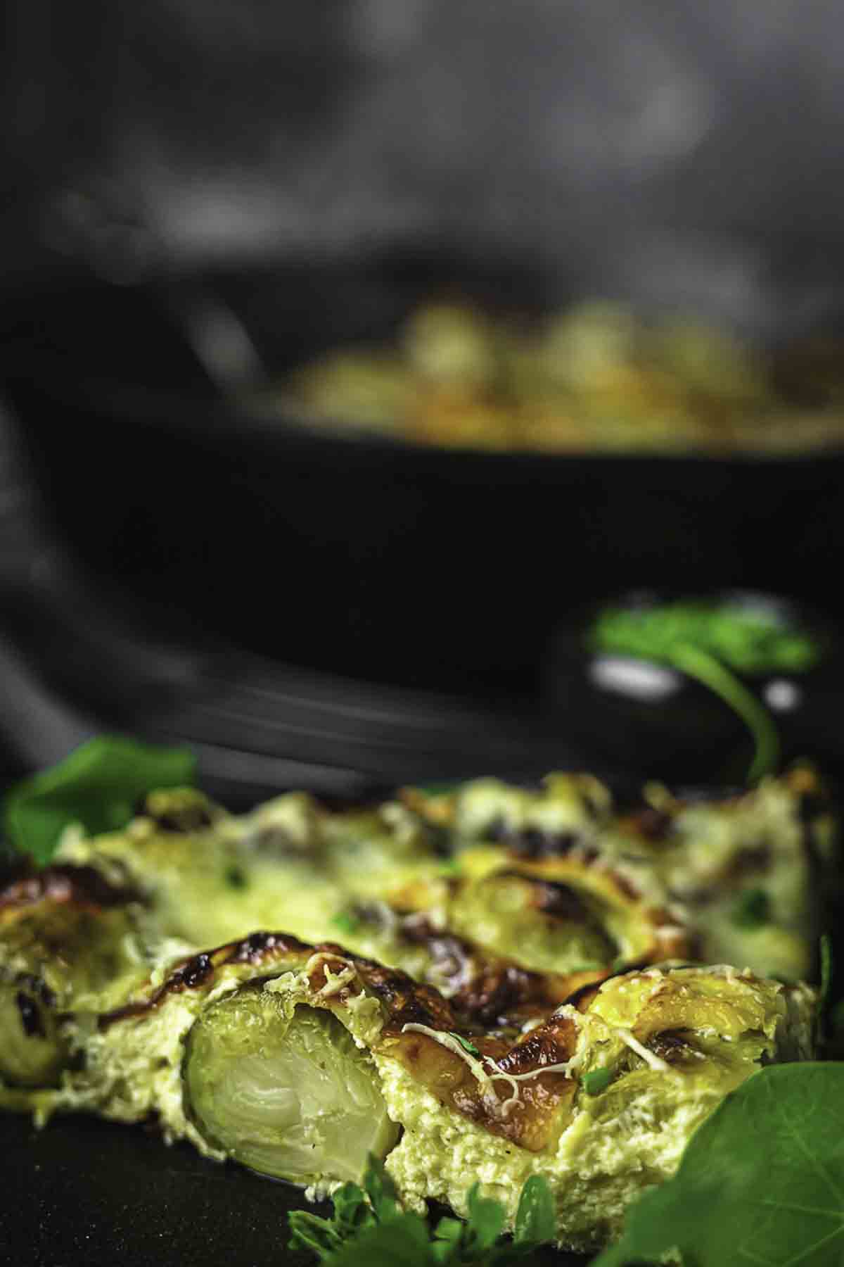 A small plate with a slice of brussel sprouts.