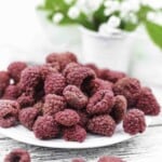 Red dry raspberries on a plate.