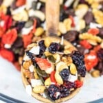 A spoon of nuts trail mix.