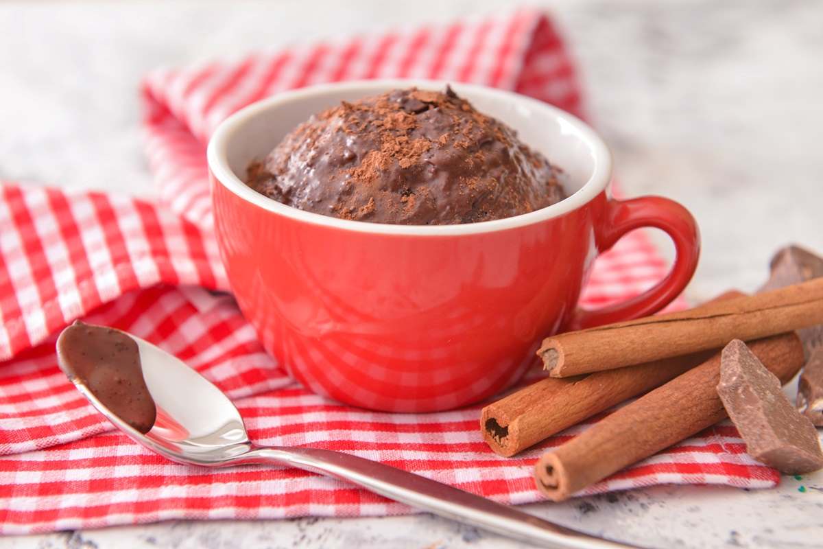 A red cup filled with chocolate mug cake.