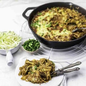 Beef casserole skillet with cabbage sides.