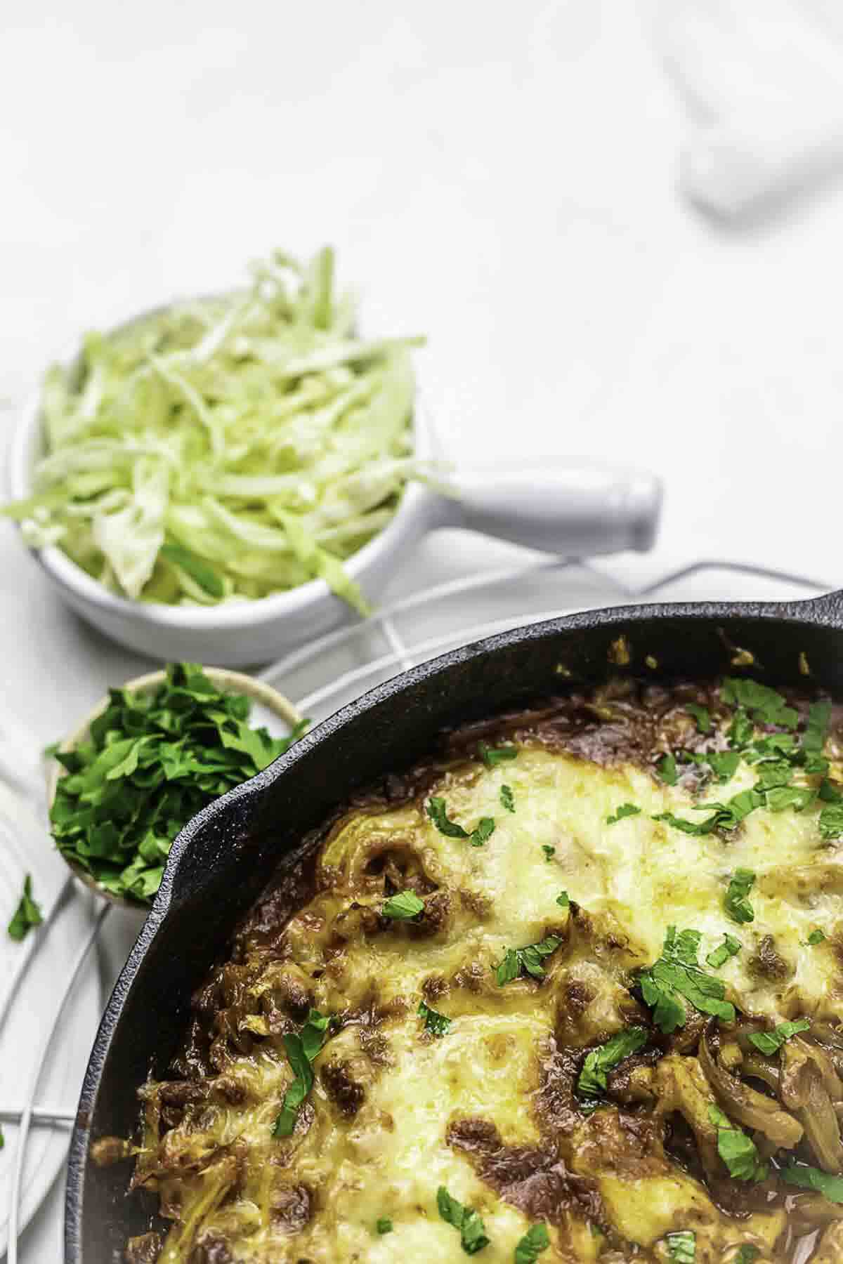 Cheesy beef casserole with cabbage sides.