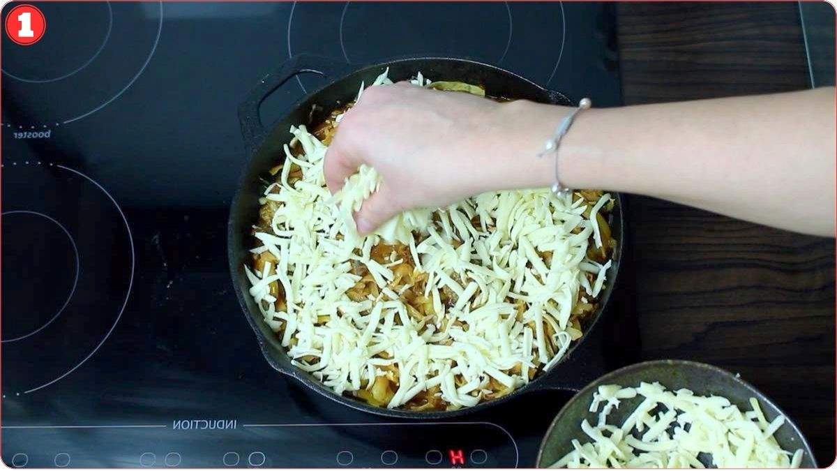 Sprinkling cheese over casserole in skillet.