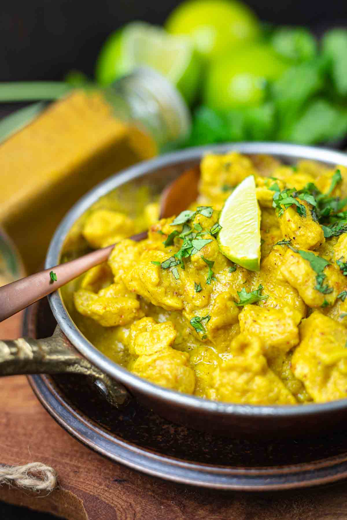 Chicken curry with lime and cilantro garnish.