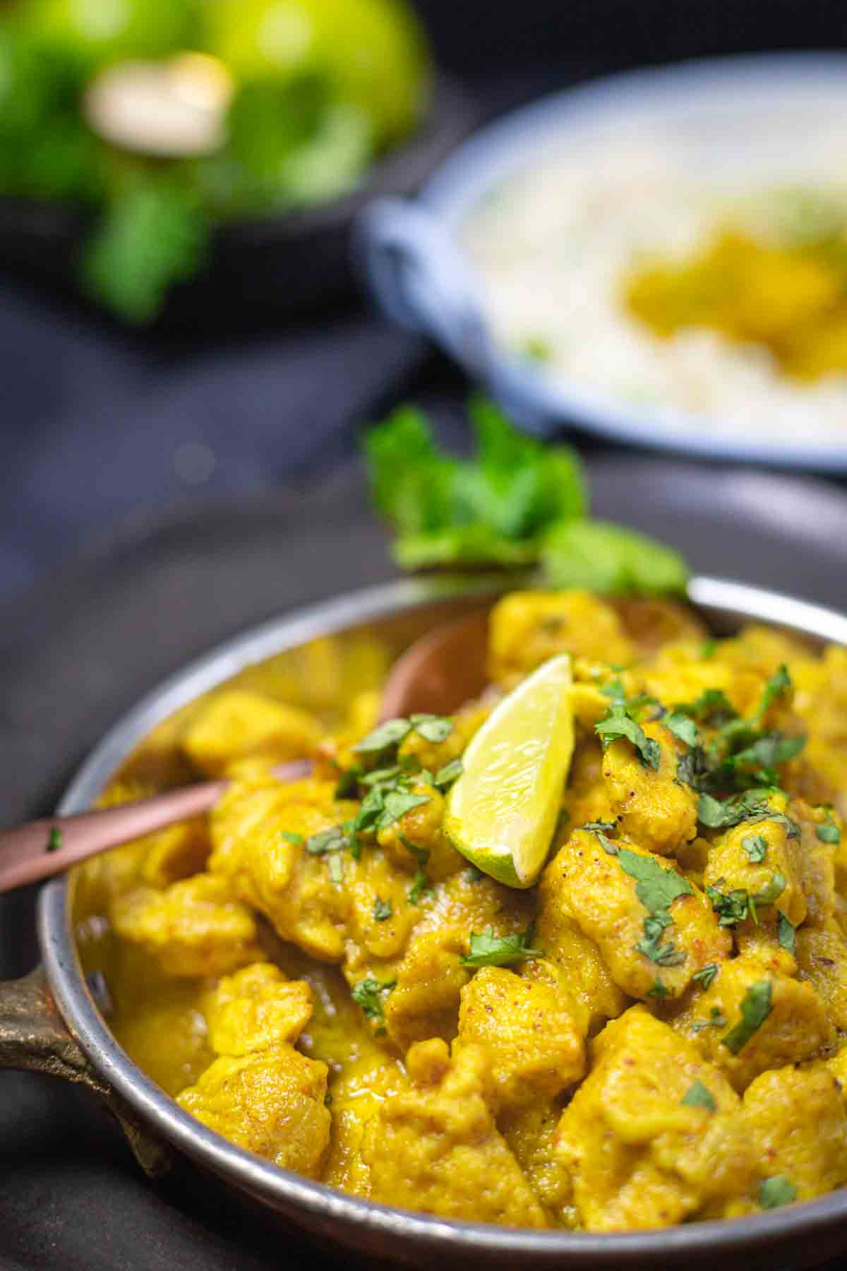 Chicken curry garnished with lime.