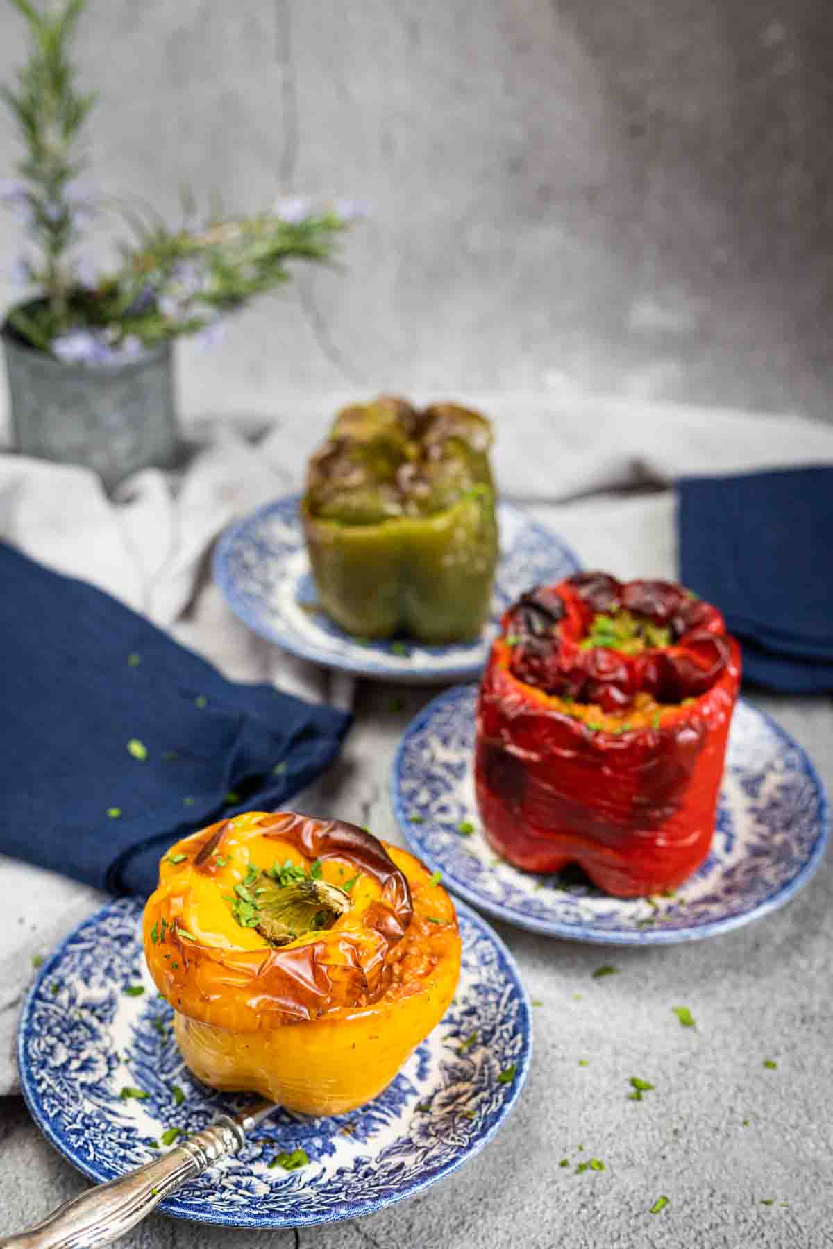 Stuffed peppers on patterned plates.