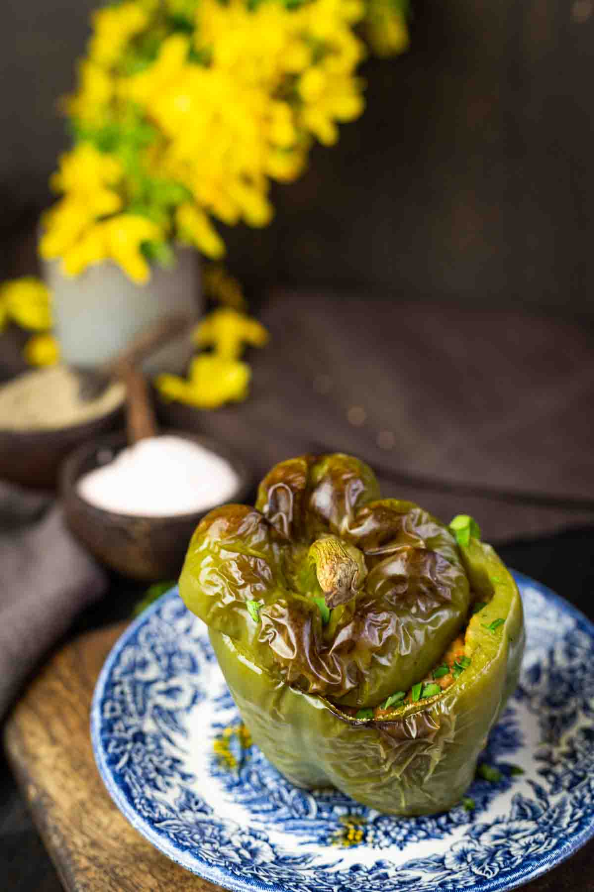 Stuffed green bell pepper on a plate.