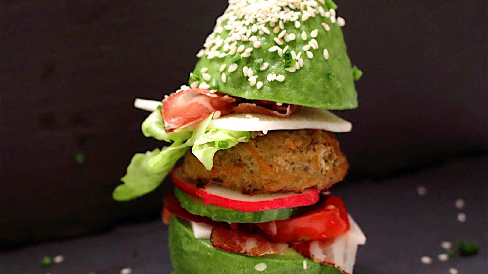 This delicious avocado burger features a juicy ground beef patty nestled between fresh lettuce, tomato, and cucumber, all topped off with an avocado half in place of the traditional bun. Sprinkled with sesame seeds for that perfect finishing touch, this is a must-try for ground beef recipe enthusiasts!.