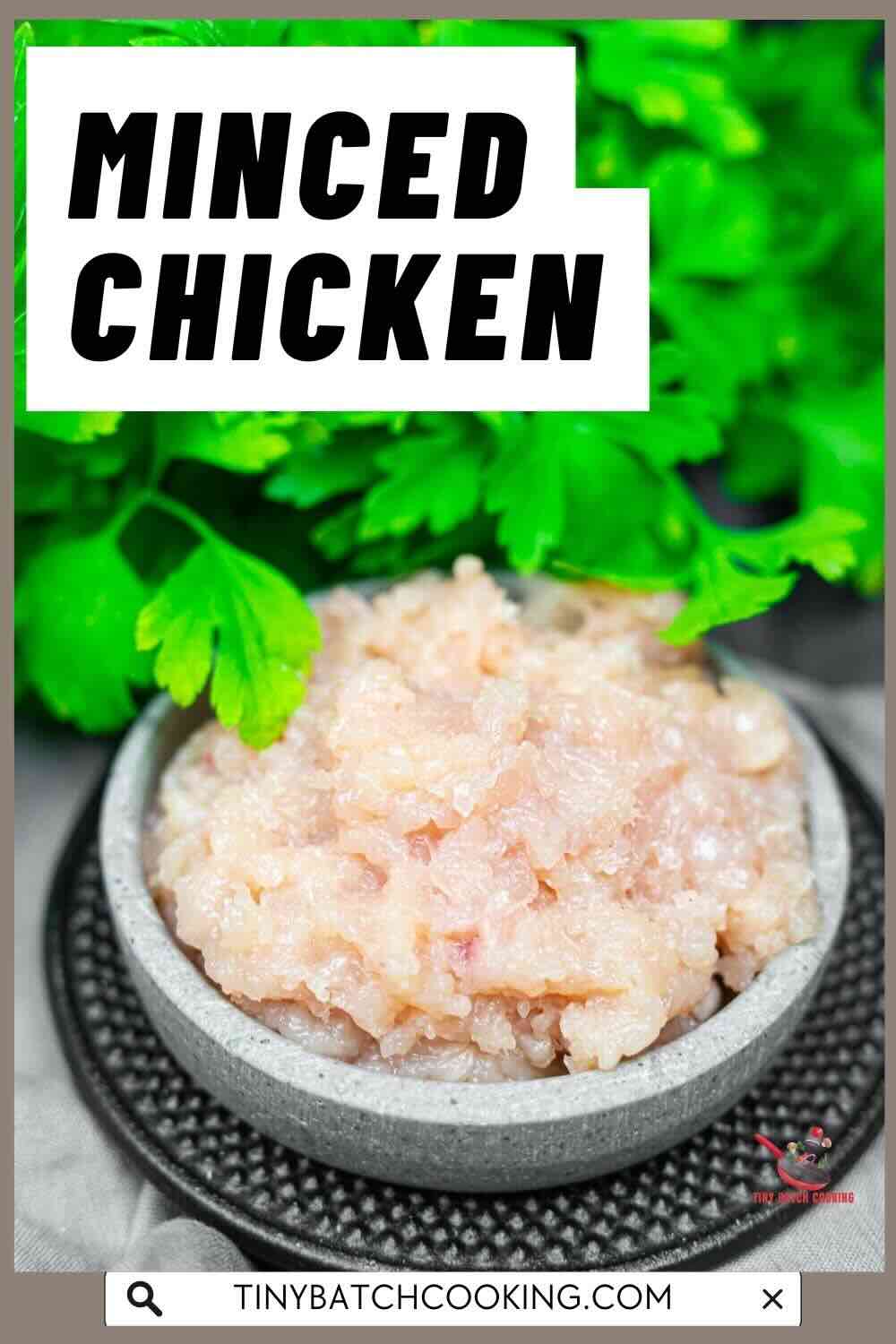 A bowl of raw minced chicken placed on a dark plate, with fresh parsley in the background. Text on the image reads "Minced Chicken.