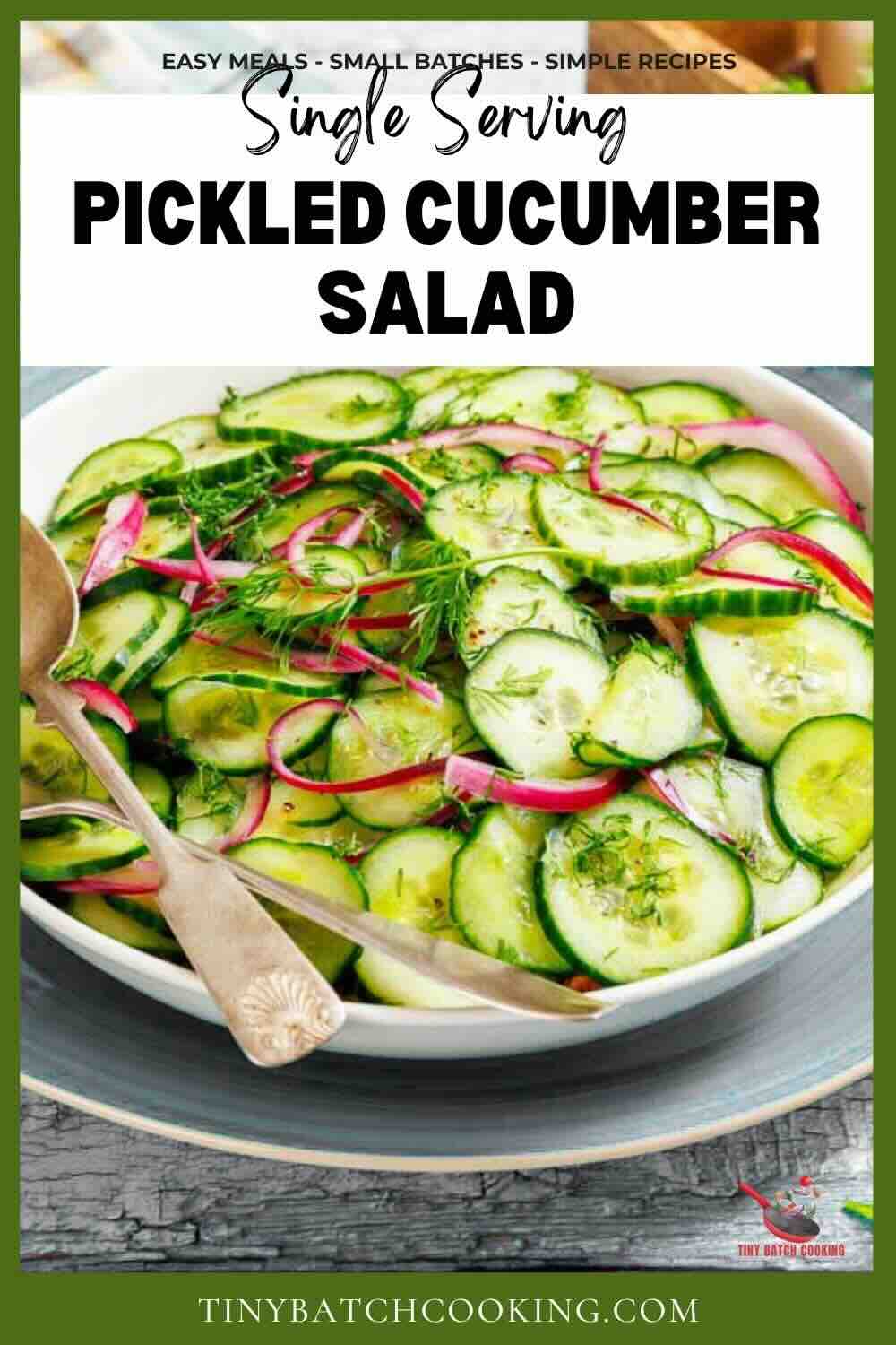 A bowl of pickled cucumber salad with sliced cucumbers, red onions, and fresh dill, served with a silver spoon.
