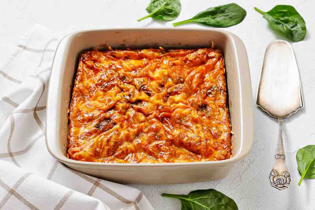 Square dish filled with cheesy egg casserole.