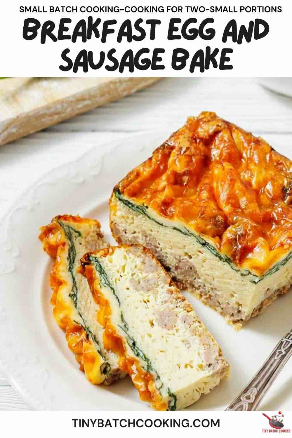 A slice of breakfast egg and sausage bake with visible layers of egg, sausage, spinach, and melted cheese on a white plate.