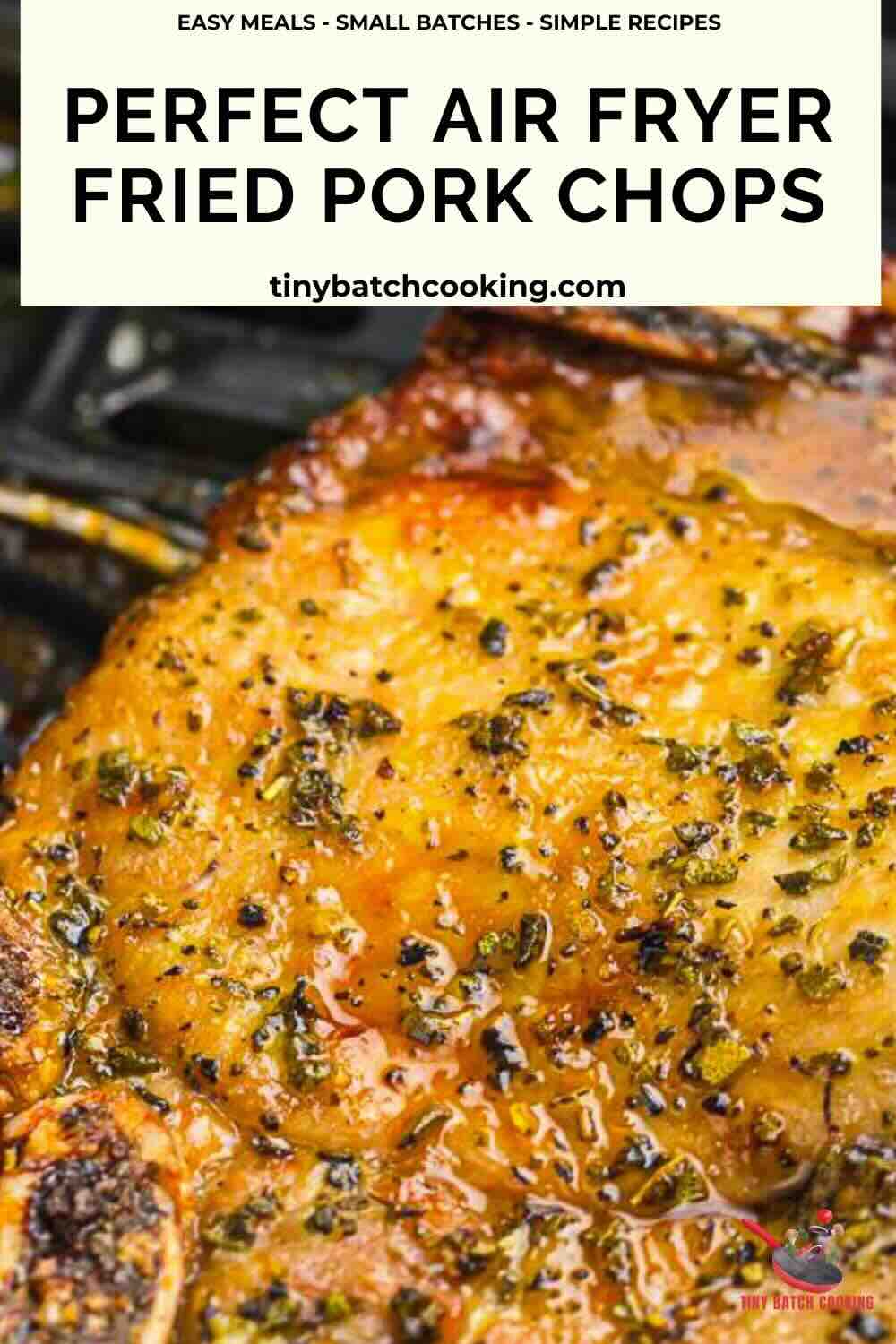 Close-up of a seasoned, golden-brown fried pork chop cooked in an air fryer, with herbs visible on the surface. Text reads: “Perfect Air Fryer Fried Pork Chops.”.