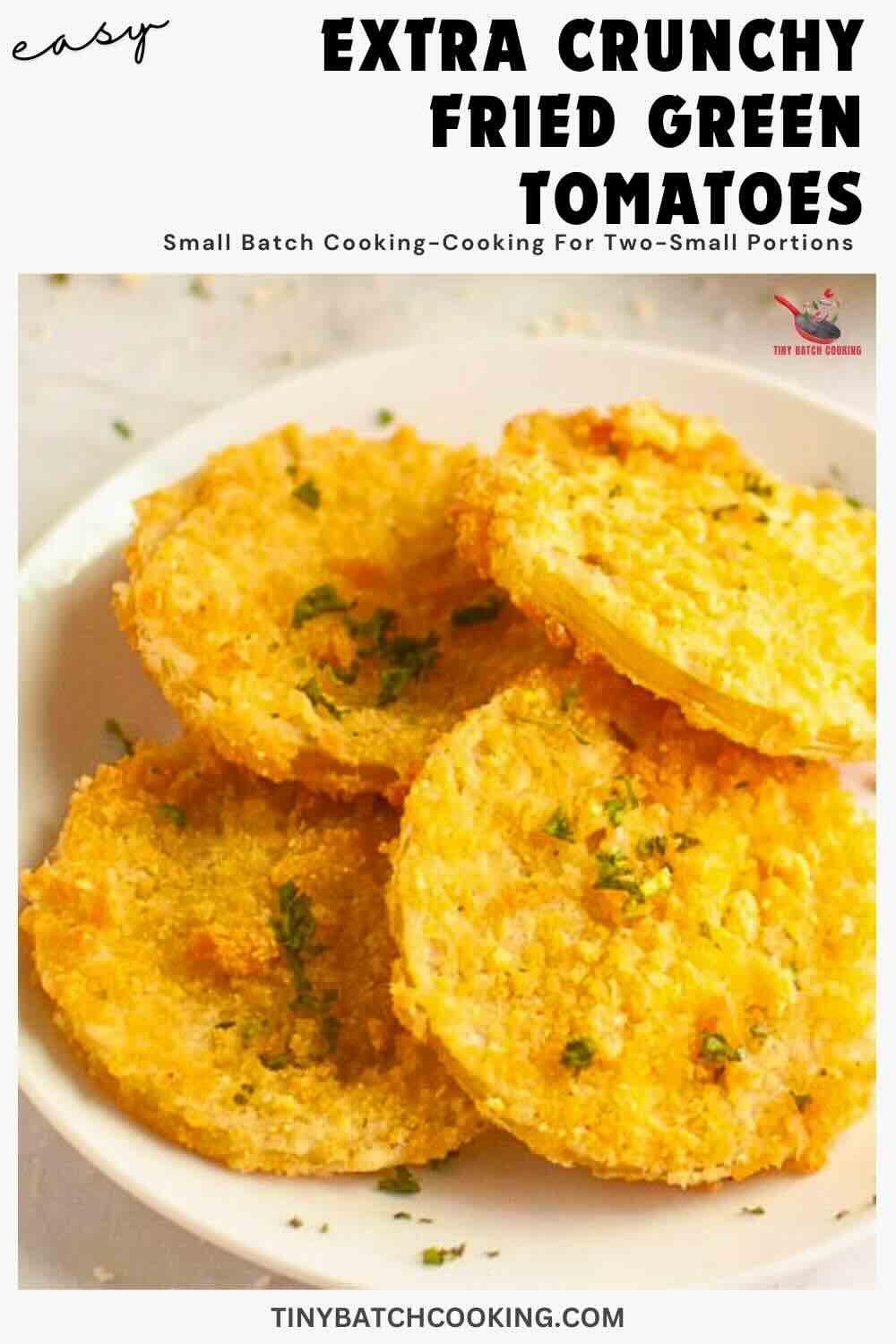 A plate of extra crunchy fried green tomato slices garnished with herbs, displayed on a light surface.