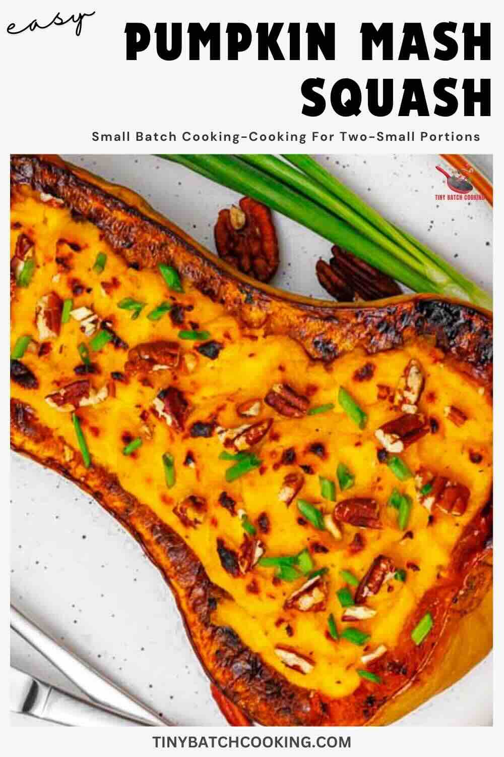 Roasted butternut squash half filled with pumpkin mash, topped with chopped pecans and green onions, on a white plate.
